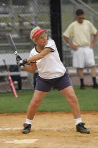 bigstock-Senior-woman-at-bat-in-softbal-26017139